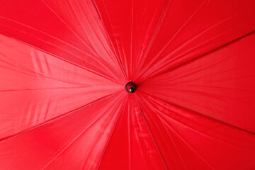 Bright red umbrella as background, closeup view