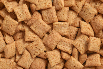 Heap of breakfast cereal pads texture or background