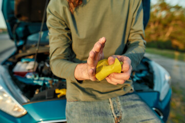 Close up of hands of man driver wiping his hands off after repairing broken car on the road side