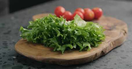 frisee salad leaves on olive board