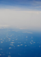 Fototapeta na wymiar Clouds and sky from airplane window view