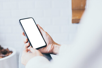 cell phone mockup blank white screen.woman hand holding texting using mobile on desk at coffee shop.background empty space for advertise.work people contact marketing business,technology