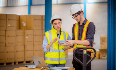 Factory engineer under inspection and checking quality production process on face mask manufacture  station by  wearing casual uniform and safety helmet in factory plantation.