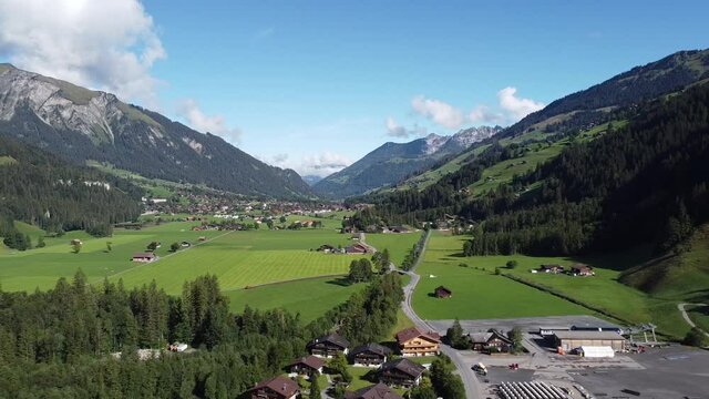 Aerial view of the Simmental Valley in Switzerland on a sunny day, drone footage