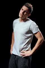 handsome man in white t-shirt on black background inflated arm muscles sport model cropped view Copy Space