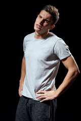 Fototapeta premium handsome man in white t-shirt on black background inflated arm muscles sport model cropped view Copy Space