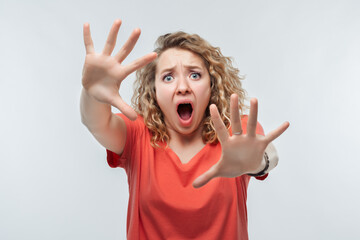 Image of scared blonde girl. Fright, phobia and facial expression concept. Studio shot, white background, isolated