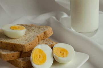 Sliced Whole Wheat Bread, Boiled Egg and Milk for Breakfast.