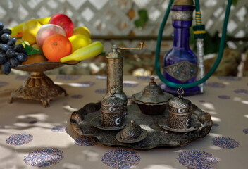 traditional oriental hookah on table with fruit