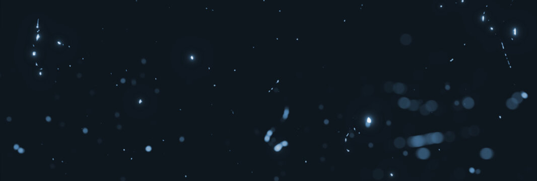 blurred blue sparks and particles in front of black backgound