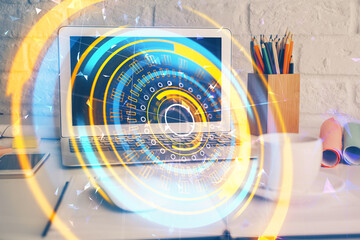 Computer on desktop in office with technology theme hologram. Double exposure. Tech concept.