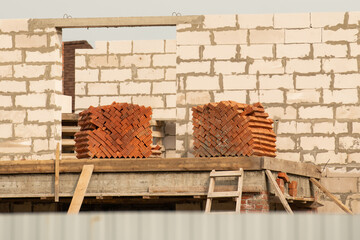 Pile of red brick at house construction site