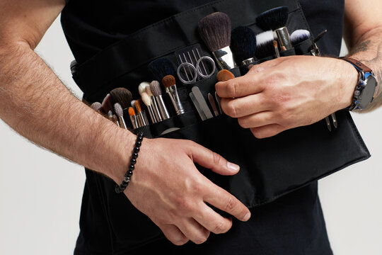 Professional Make-up Artist With Belt Bag With Makeup Brushes. Stylist At Work.