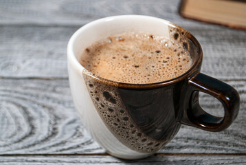 Cup of coffee on the table with beautiful foam