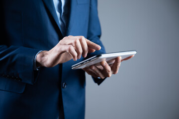 businessman holds tablet in hand