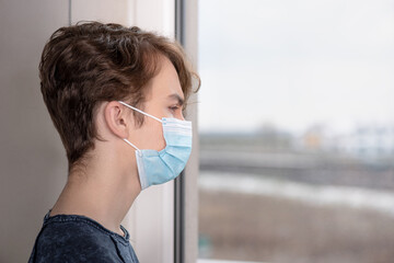Concept of coronavirus quarantine. Child wearing medical protective face mask during flu virus,...