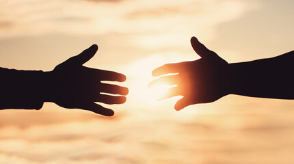 Giving a helping hand. Rescue, helping gesture or hands. Mercy, two hands silhouette on sky...