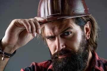 Building, industry, technology - builder concept. Bearded man worker with beard in building helmet...