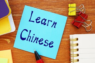 Business concept about Learn Chinese with inscription on the piece of paper.