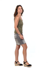 side view of the full portrait of a woman in a denim skirt walking on white background,