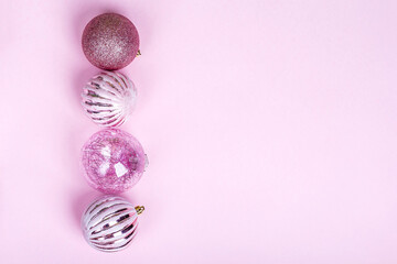 Christmas composition. Set of christmas pink decorations, shiny balls on pastel background. Mock up for new year gretting card. Copy space for text or lettering
