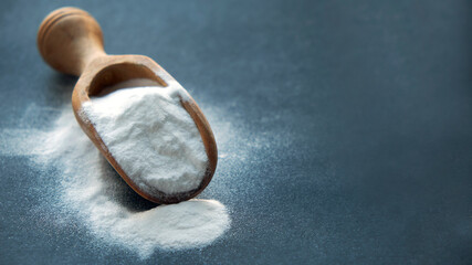 Glass bowl of baking soda. Spoonful of bicarbonate.