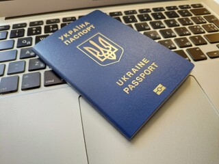 Ukrainian passport for travel near laptop, business