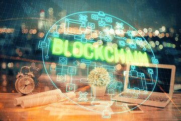 Double exposure of blockchain theme hologram and table with computer background. Concept of bitcoin...