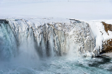 Scenic winter view of Godafoss waterfall in Iceland. Picturesque winter landscape with frozen waterfall in Iceland.