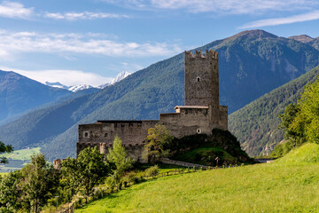 The ancient Prince's Castle of Burgusio, South Tyrol, Italy, with the snow capped Alps in the background