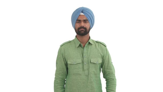 Smiling beard Indian man making heart with his hands. Hand heart gesture. Symbol of love. Isolated on white background.