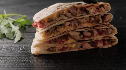 Quesadilla close-up on a black wooden table. - Powered by Adobe