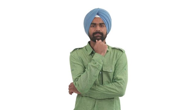 Young beard Indian man stroking his chin, nodding satisfied and thinking about something pleasant. Isolated on white background.