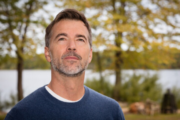 Handsome Mature Man lost in thought. Looking the sky. He is a dreamer.