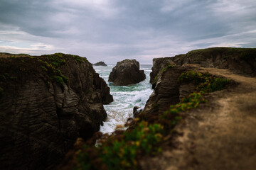 Fantastic big rocks and ocean waves. Dramatic scene. Landscape view. High quality photo