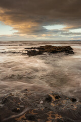 Sunrise over rough seas.