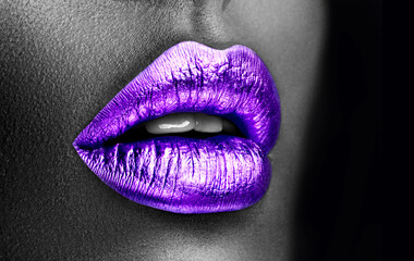 Fototapeta premium Purple lipstick closeup. Violet metal lips. Beautiful makeup. Sexy lips, bright lip gloss paint on beauty model girl's mouth, close-up. Lipstick. Black and white image