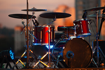 Fototapeta na wymiar A photo of a red drum kit on stage