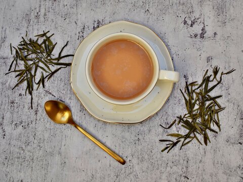 Yellow Tea With Cup And Spoon