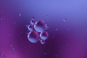 Fantastic oil drops on ble-purple background