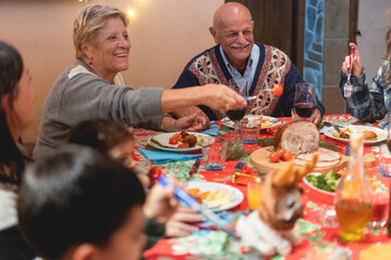 Happy family having dinner at home - Holiday concept - Focus on grandfather face