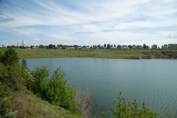 Flooded open pit quarry with blue water lake