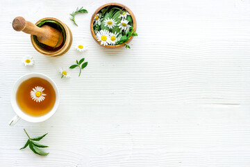 Fototapeta na wymiar Top view of herbal tea in cup with herbs in bowls, top view