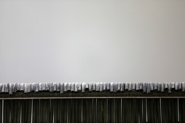 Enamel steel sheets are suspended on the production line in a factory in China.