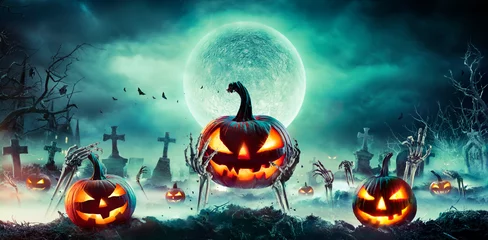 Foto op Plexiglas Jack O’ Lantern On Skeleton Arms In Graveyard At Night - Halloween With Full Moon © Romolo Tavani