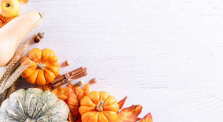 Autumn background decoration from dry leaves and pumpkin on  wooden background. Flat lay, top view for Autumn, fall, Thanksgiving concept.