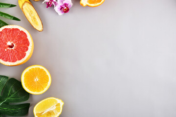 Concept on a gray background. Tropical fruits. Frame.	