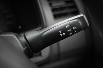 Switch off lights in a car. close-up Car integrated turning indicator with headlight switch toggle.