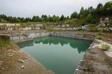 Fototapeta premium Flooded limestone marble quarry mine