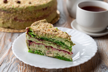 Slice of green pistachio cake on a plate